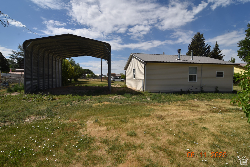 View of yard with a detached carport