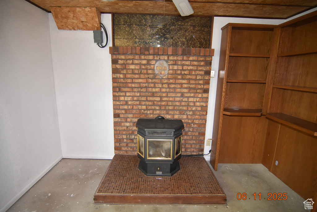 Detailed view of unfinished concrete floors and a wood stove