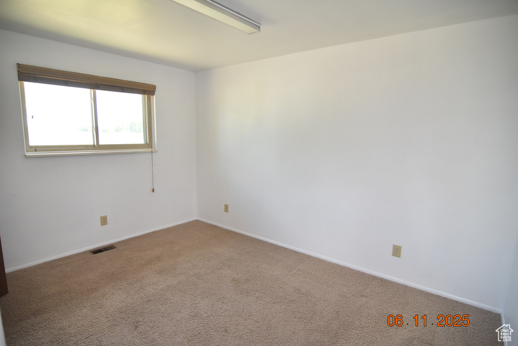 Spare room with carpet flooring and baseboards