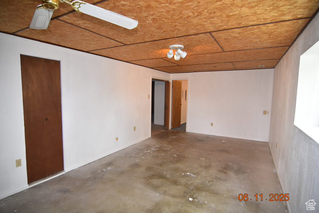 Spare room featuring unfinished concrete flooring