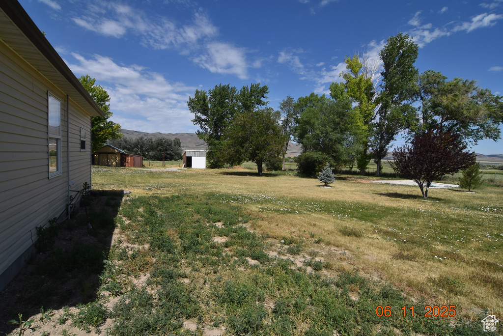 View of green lawn featuring a mountain view