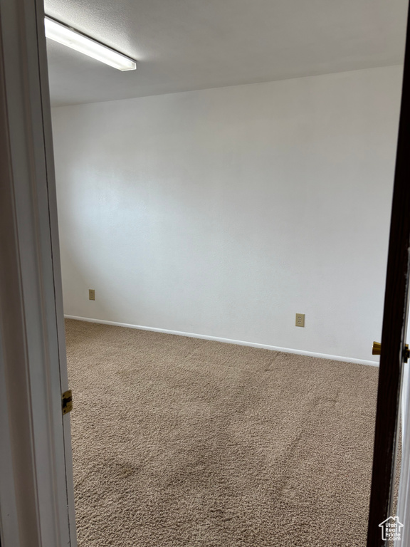 Unfurnished room with carpet and baseboards