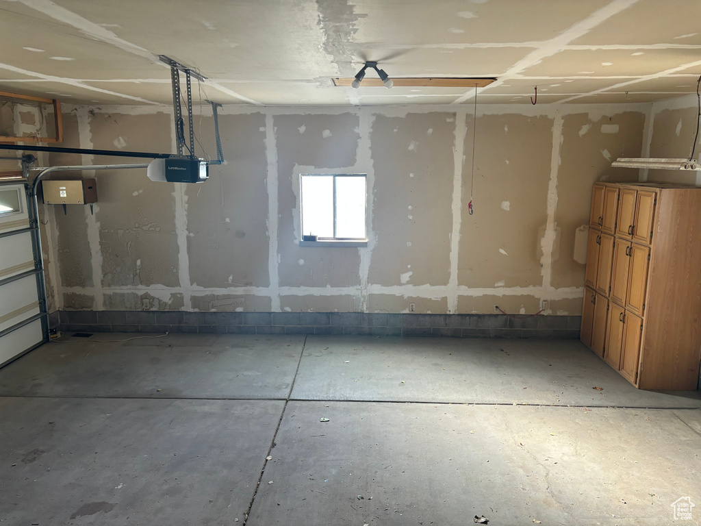 Garage featuring a garage door opener