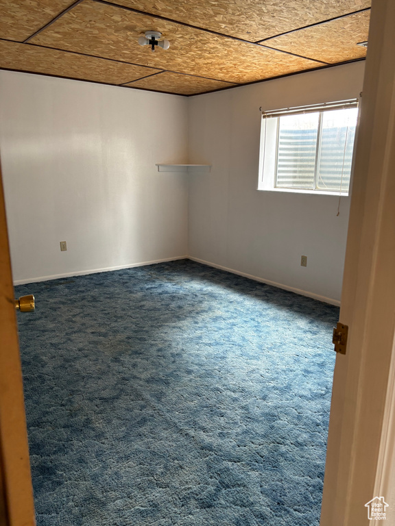 Carpeted empty room with baseboards