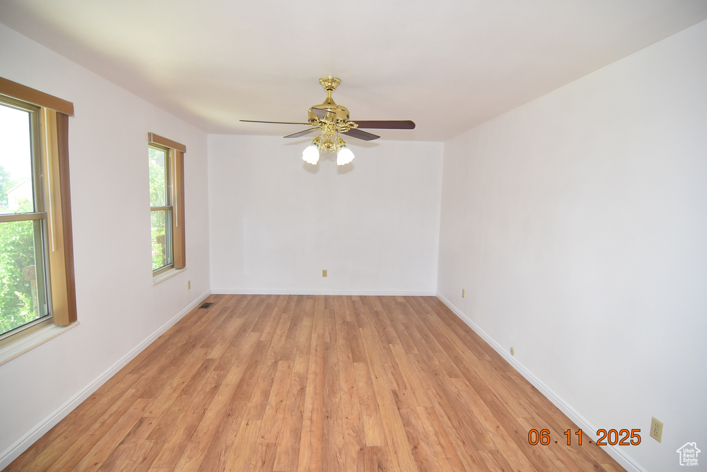 Spare room with light wood-style flooring and ceiling fan