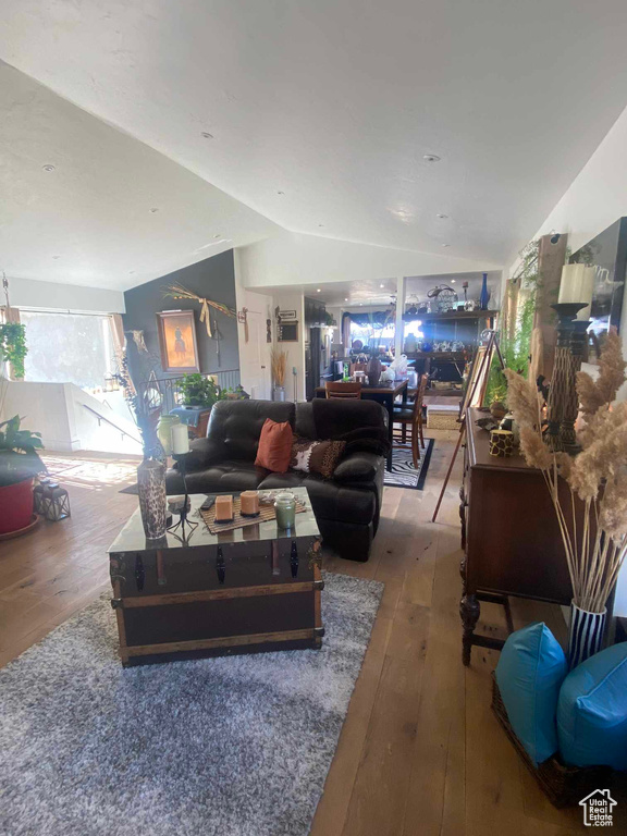 Living room featuring vaulted ceiling and hardwood / wood-style flooring