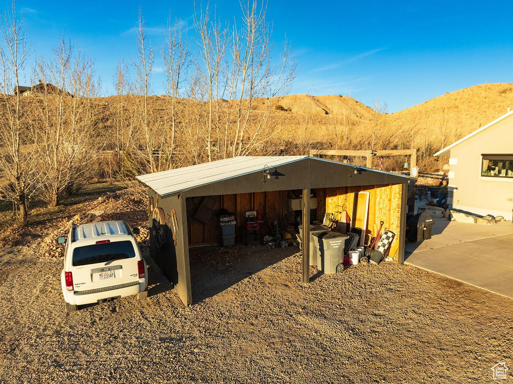 View of outdoor structure with a carport and a mountain view