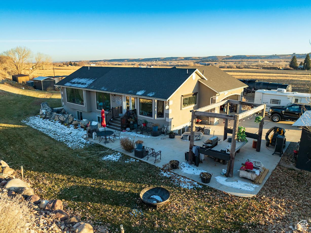 Rear view of property featuring a lawn, outdoor lounge area, and a patio