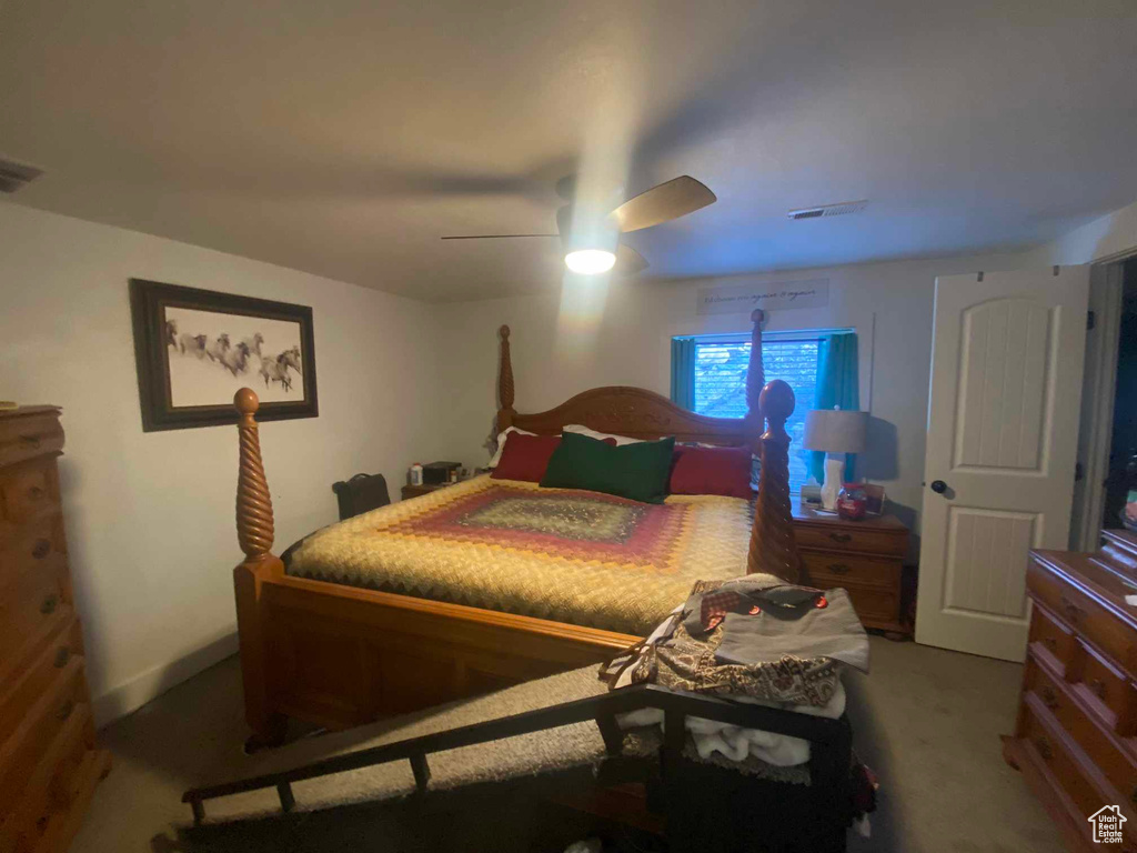 Carpeted bedroom with ceiling fan