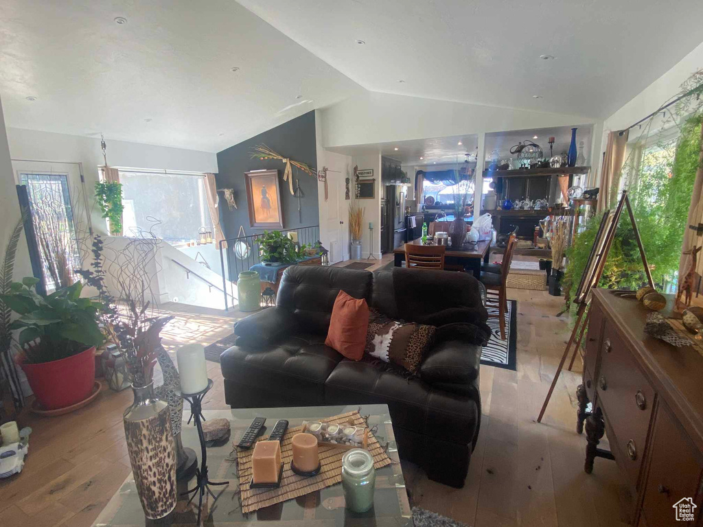 Living room featuring light wood-type flooring and vaulted ceiling