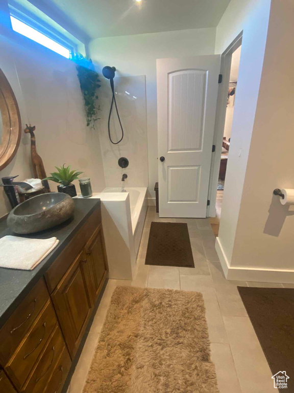 Bathroom with tile patterned floors, vanity, and bathtub / shower combination