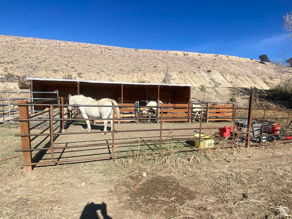 View of stable with a mountain view and a rural view