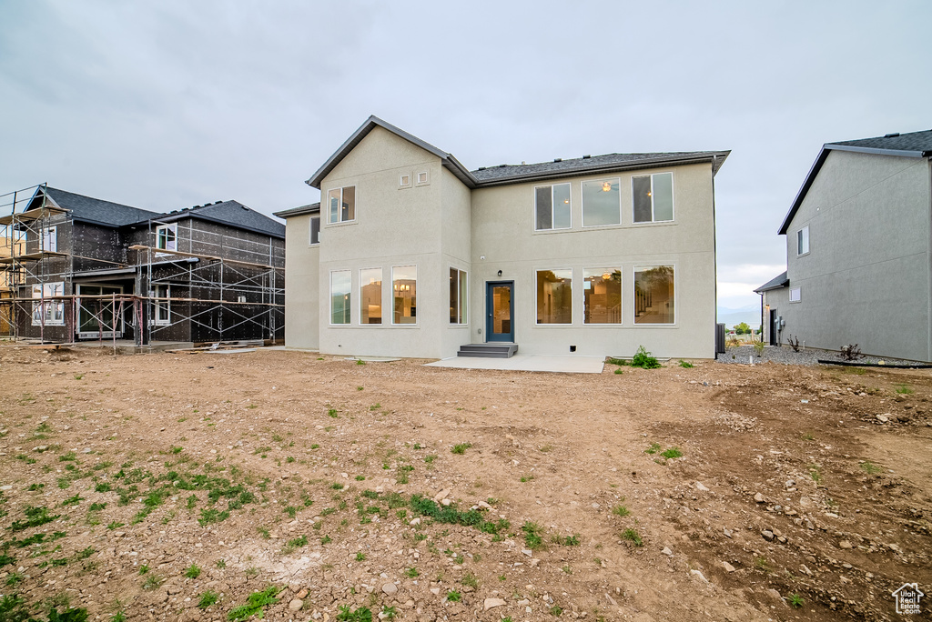 Back of property featuring a patio area and stucco siding