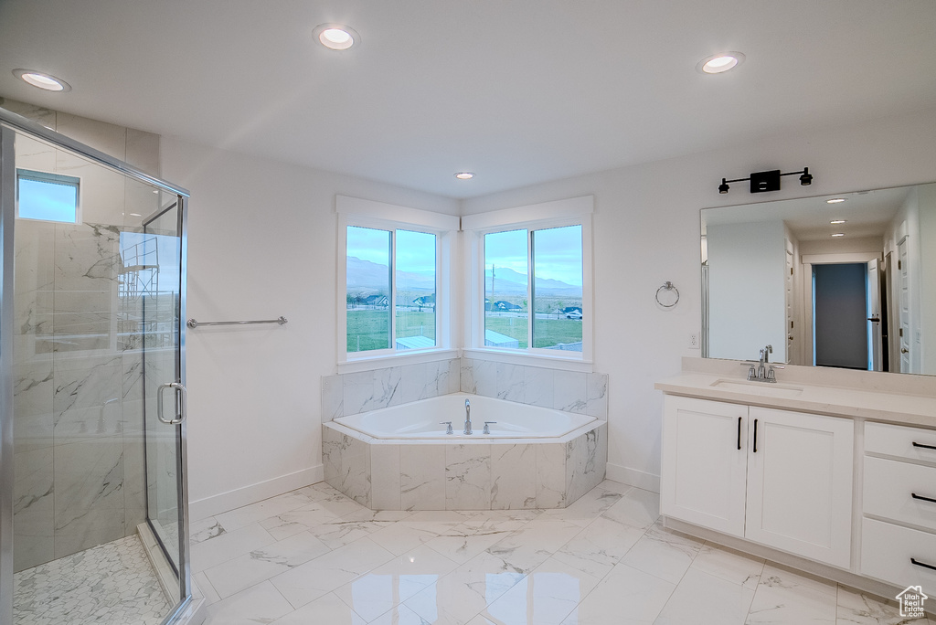 Full bathroom with a garden tub, baseboards, and a healthy amount of sunlight