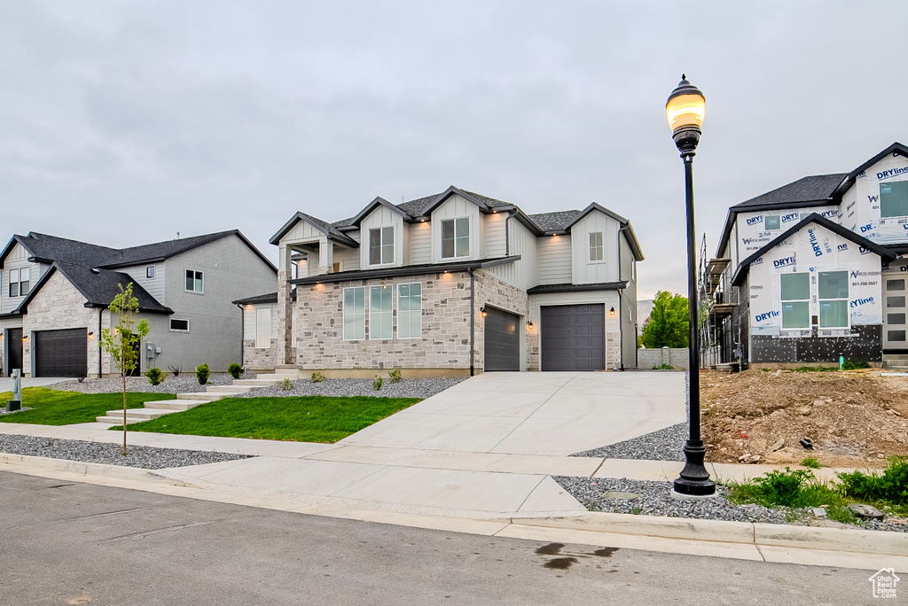 View of front of property featuring concrete driveway, board and batten siding, and an attached garage