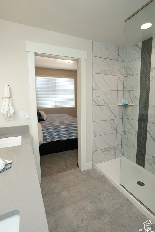 Bathroom with vanity and tiled shower