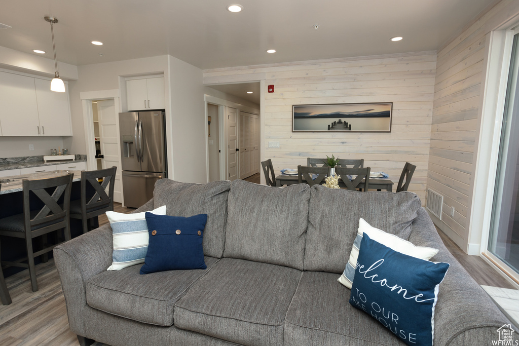Living room featuring wood walls and light hardwood / wood-style floors