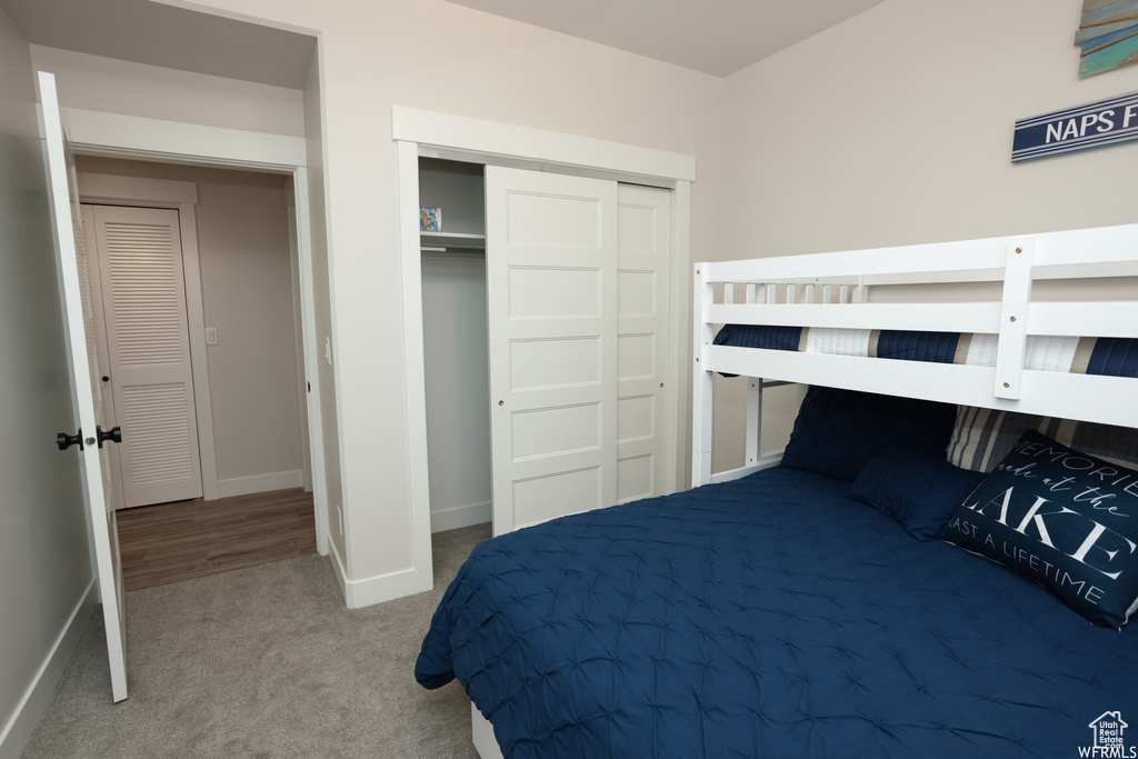 Carpeted bedroom with a closet