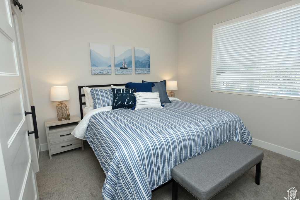Bedroom featuring light carpet