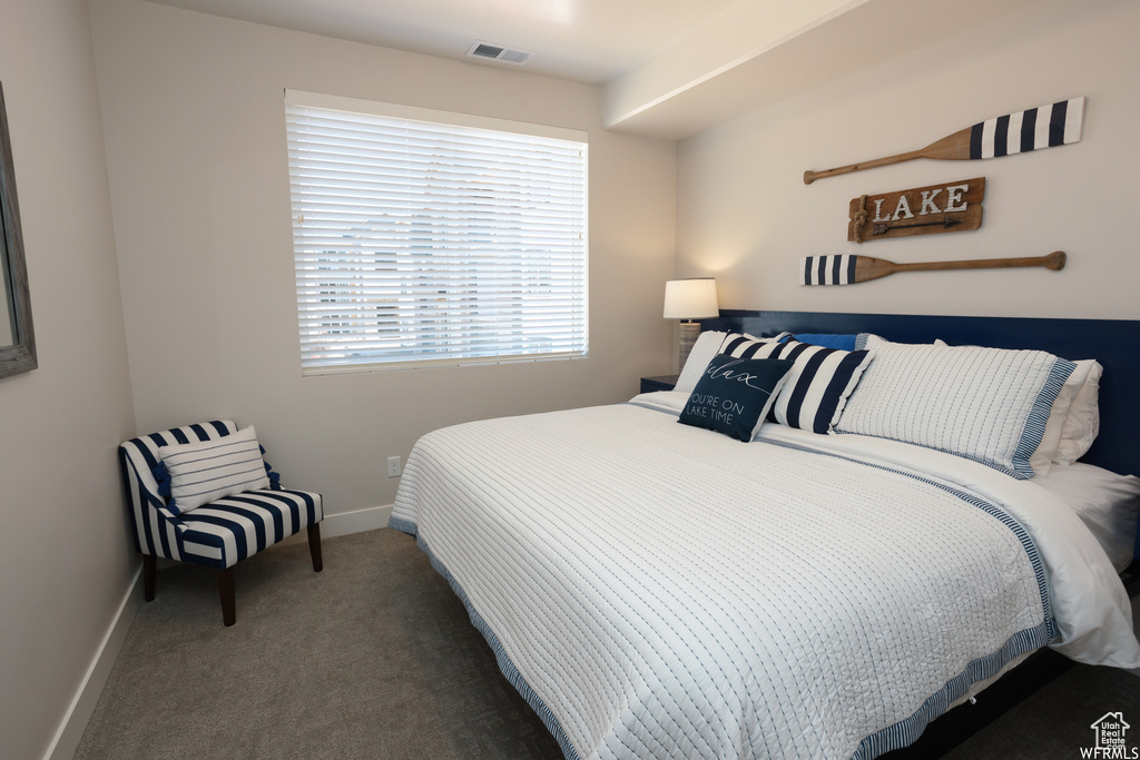 Bedroom with dark colored carpet