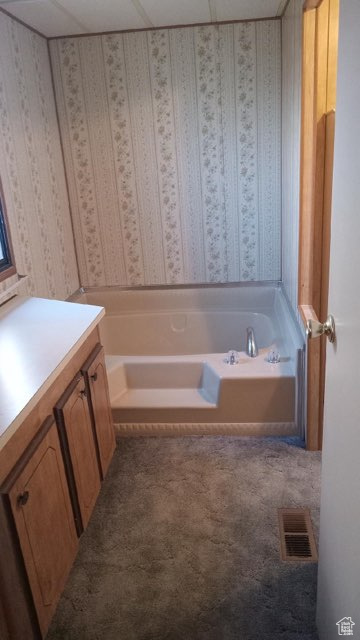 Bathroom with vanity and a bath