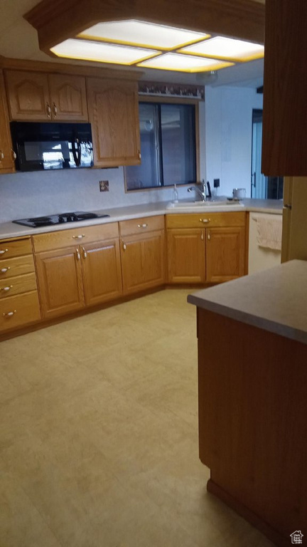 Kitchen featuring white gas stovetop and sink