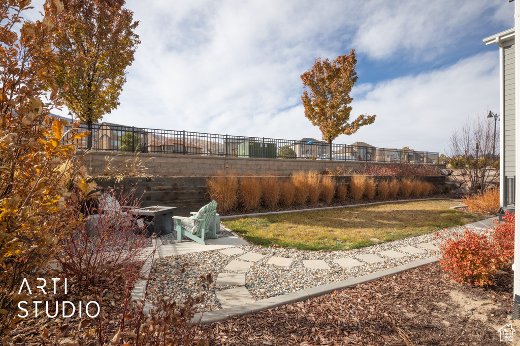 View of yard featuring a patio and an outdoor fire pit