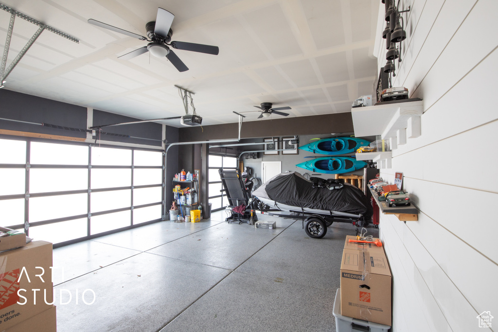 Garage featuring ceiling fan and a garage door opener