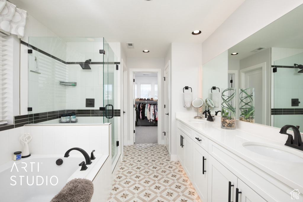 Bathroom featuring vanity and plus walk in shower