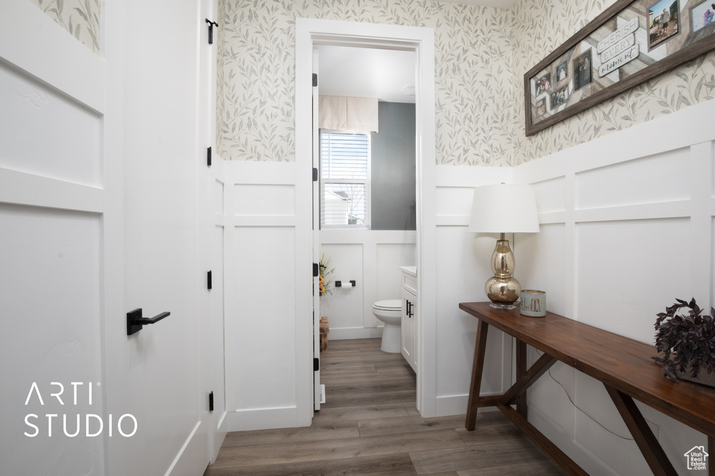 Bathroom featuring wood-type flooring and toilet