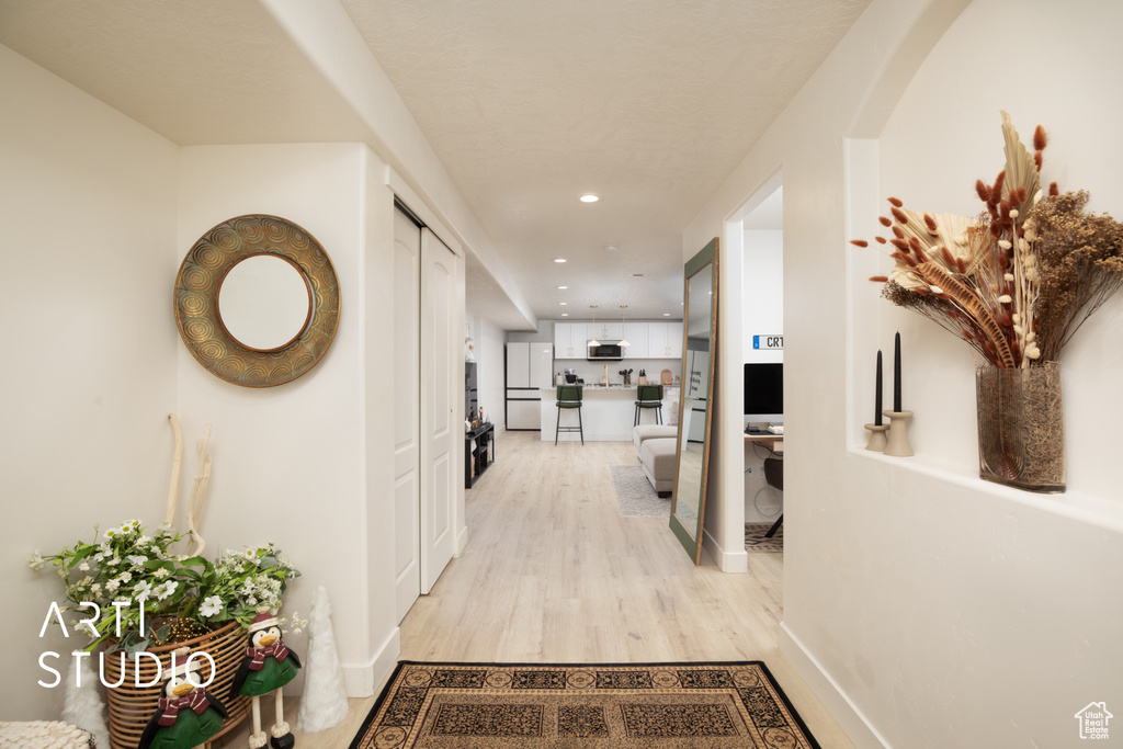 Hall with light hardwood / wood-style floors