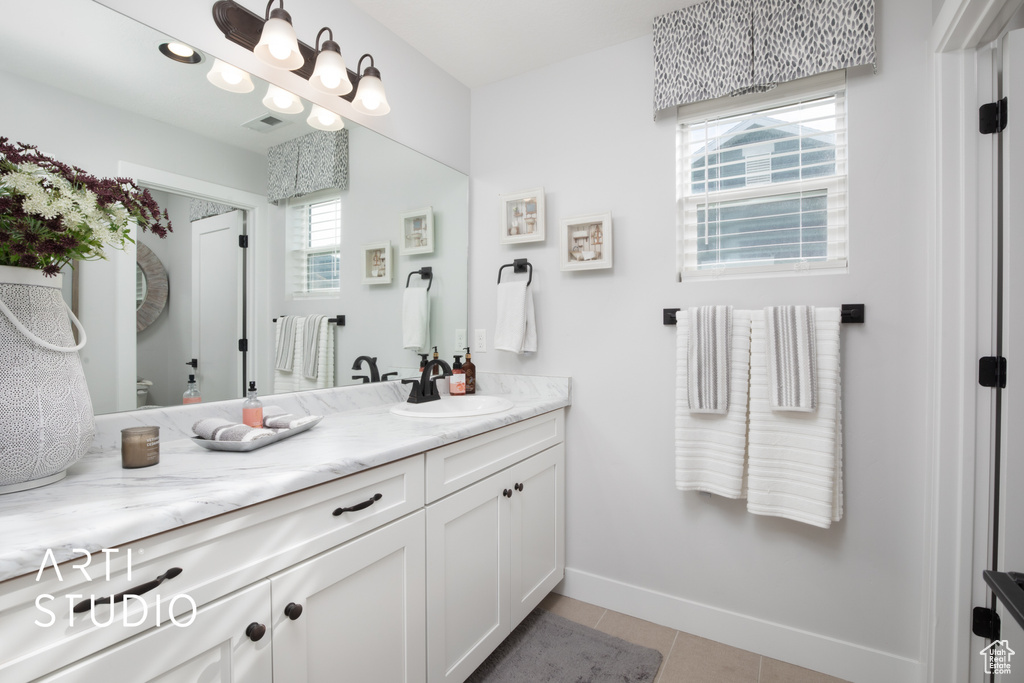 Bathroom with tile patterned flooring and vanity