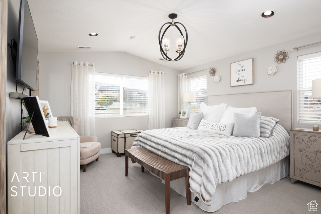 Bedroom with light carpet, an inviting chandelier, multiple windows, and lofted ceiling