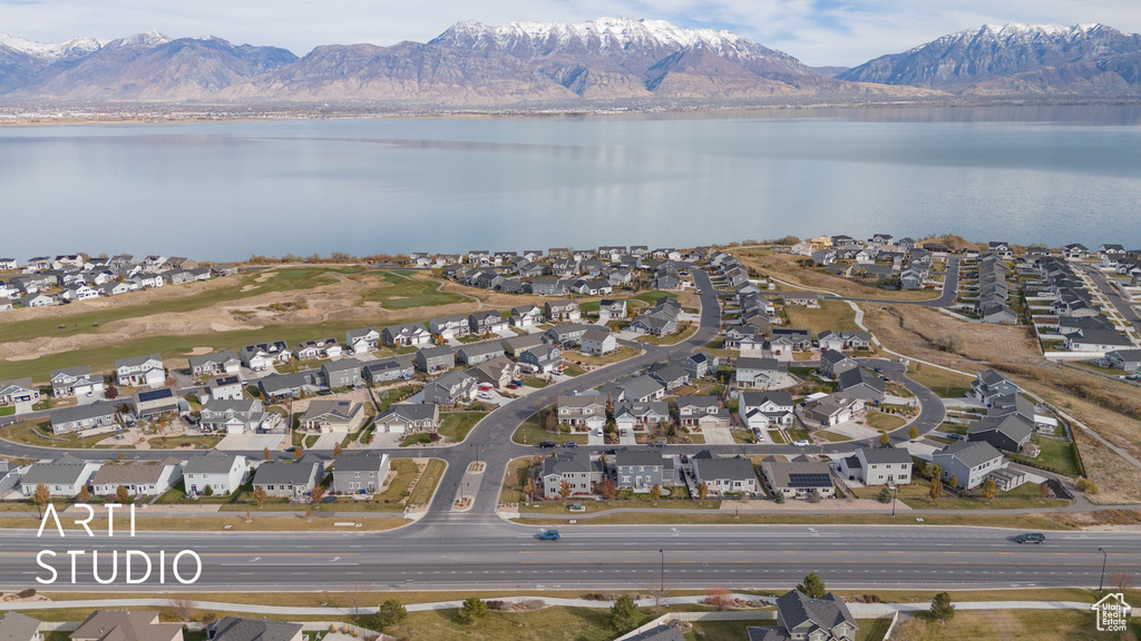 Birds eye view of property with a water and mountain view