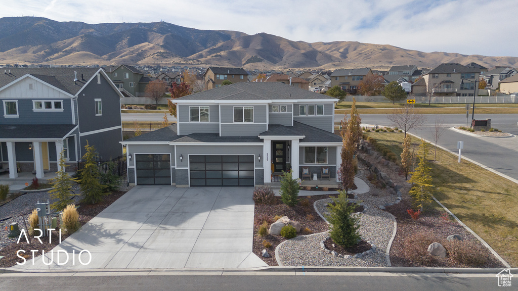 View of front of home featuring a mountain view and a garage