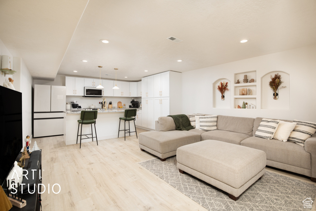 Living room with light hardwood / wood-style floors