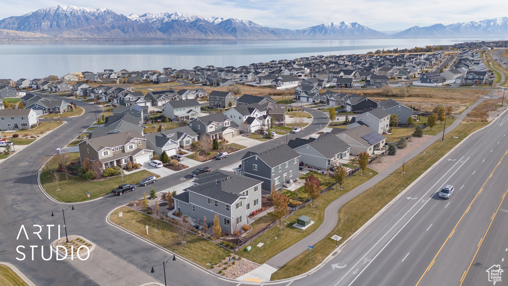 Birds eye view of property with a water and mountain view