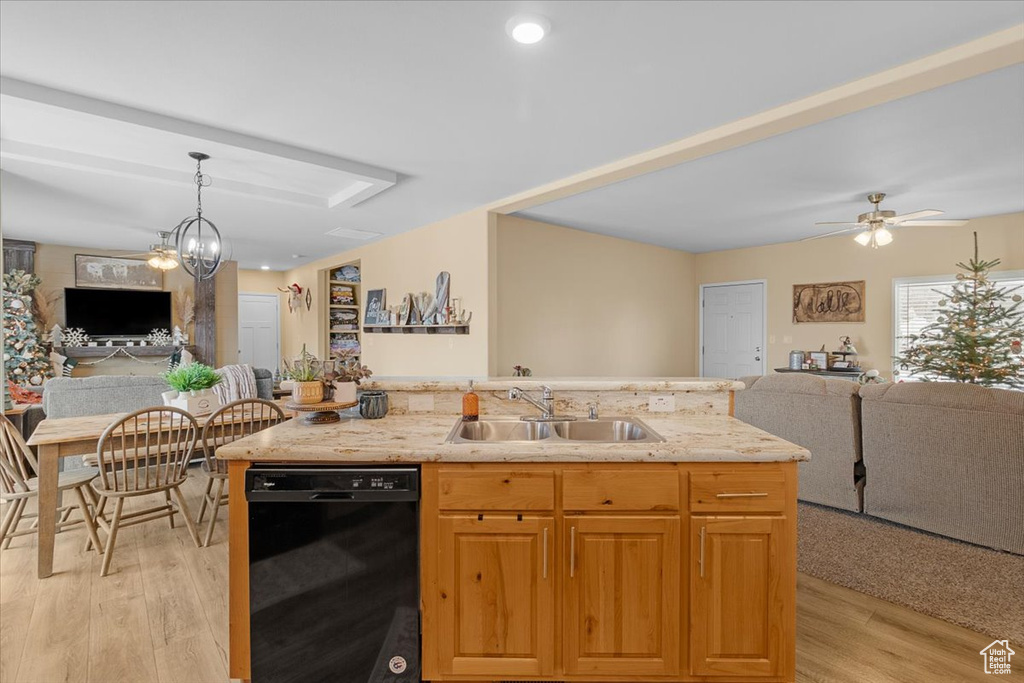 Kitchen featuring dishwasher, ceiling fan with notable chandelier, sink, light hardwood / wood-style flooring, and an island with sink