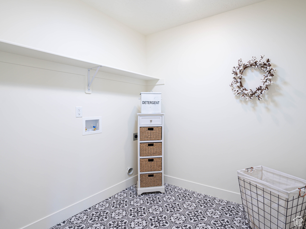 Laundry area featuring hookup for an electric dryer, light tile patterned floors, hookup for a washing machine, baseboards, and laundry area