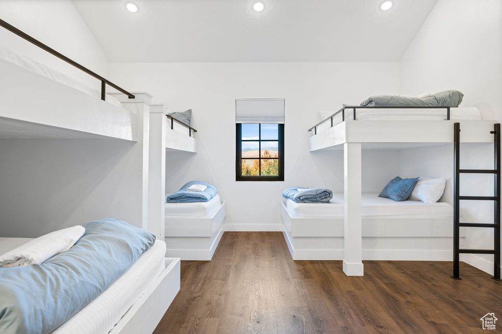 Bedroom featuring dark hardwood / wood-style floors and lofted ceiling