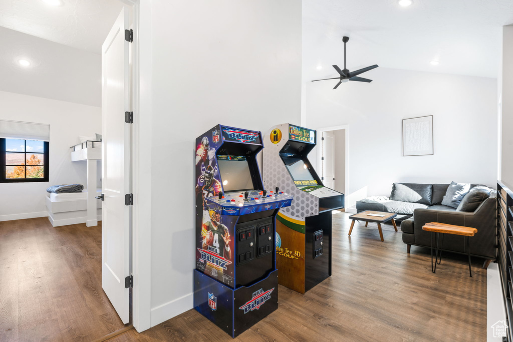 Playroom with ceiling fan, wood-type flooring, and high vaulted ceiling