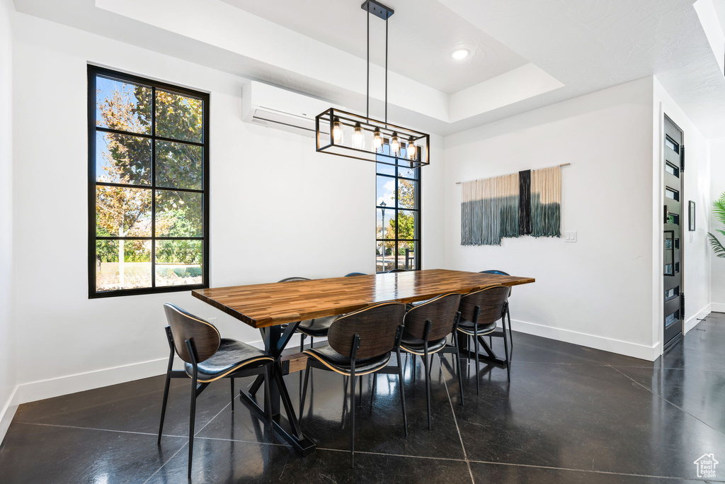 Dining area with a raised ceiling and a wall unit AC