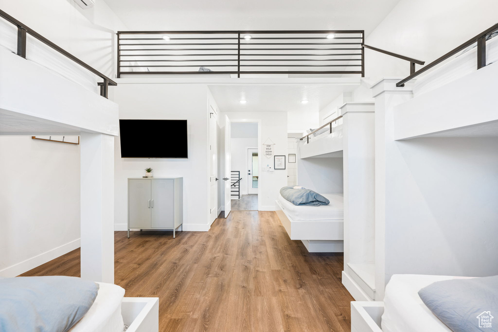 Interior space featuring light wood-type flooring and a towering ceiling