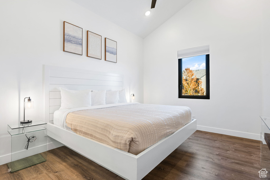 Bedroom featuring ceiling fan, high vaulted ceiling, and dark wood-type flooring