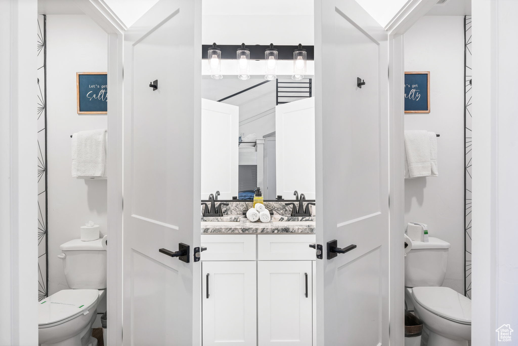 Bathroom featuring vanity and toilet