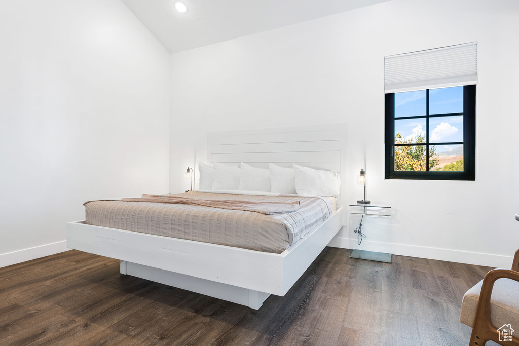 Bedroom featuring dark hardwood / wood-style floors and lofted ceiling