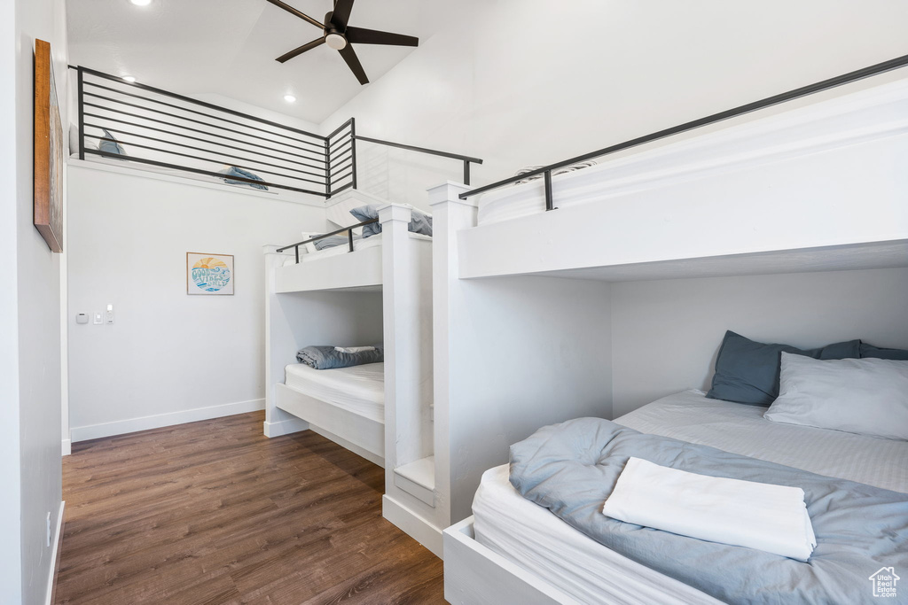 Bedroom featuring ceiling fan, dark hardwood / wood-style flooring, and vaulted ceiling