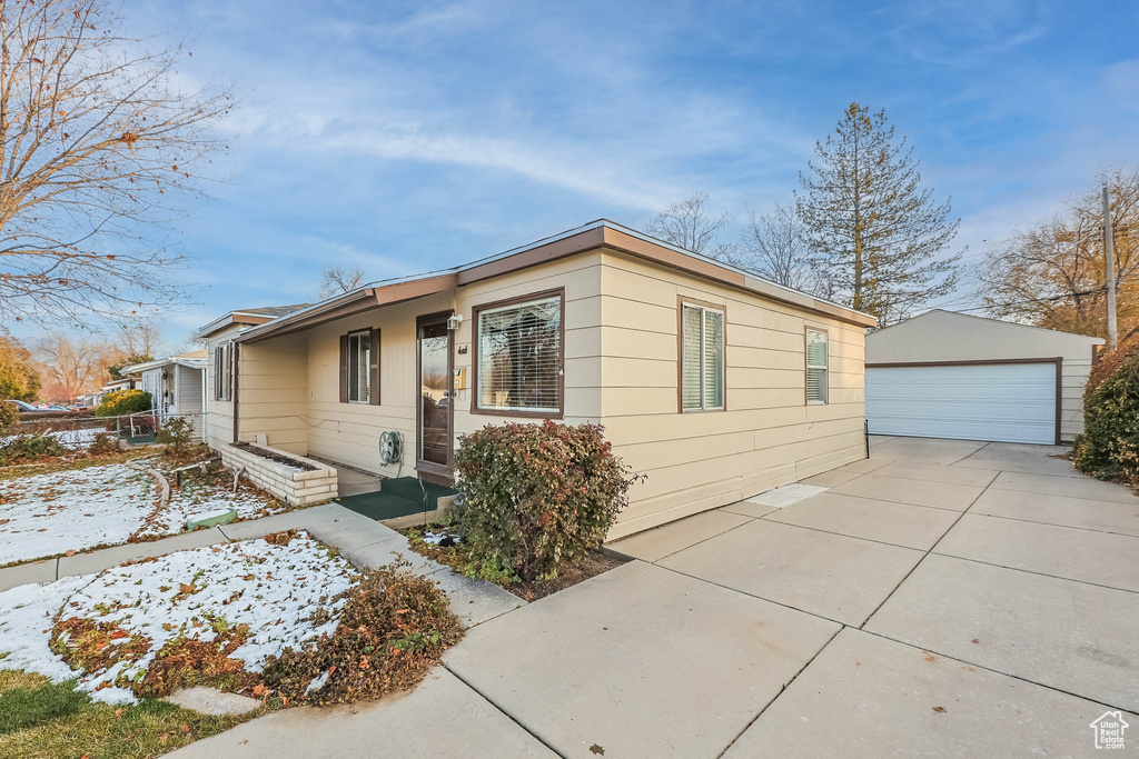 View of front of property featuring an outdoor structure and a garage