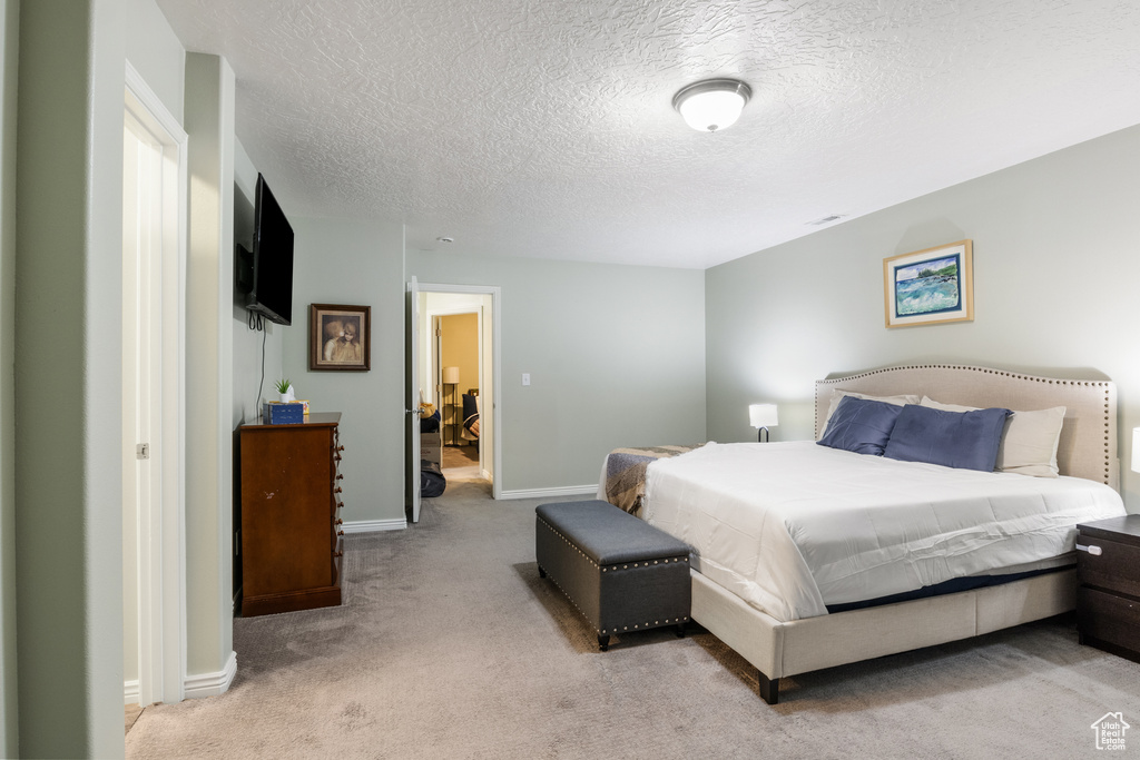 Carpeted bedroom featuring a textured ceiling