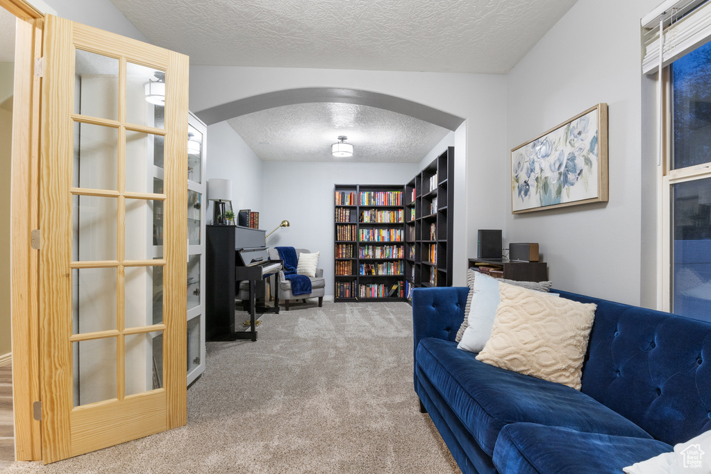 Office space featuring carpet floors and a textured ceiling